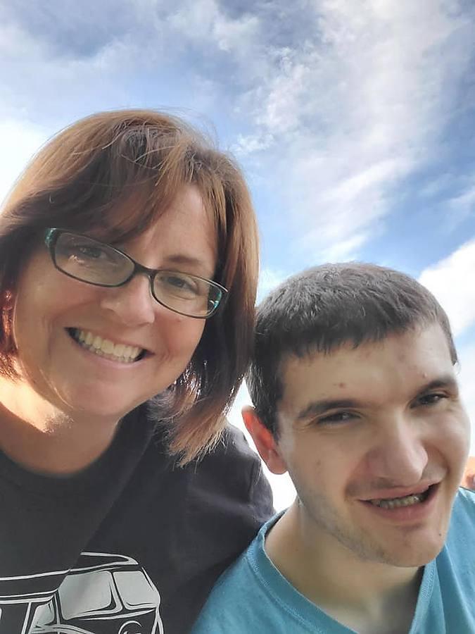 A staff member and member taking a sunny selfie together