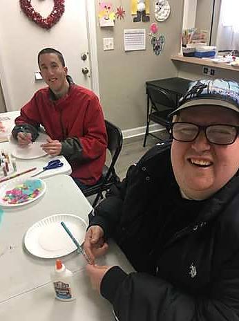 Two friends smiling during craft time