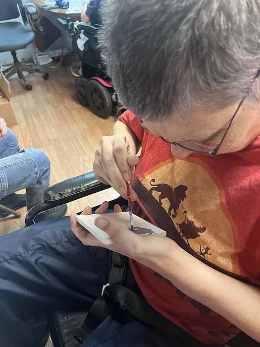 A member coloring a watermelon craft